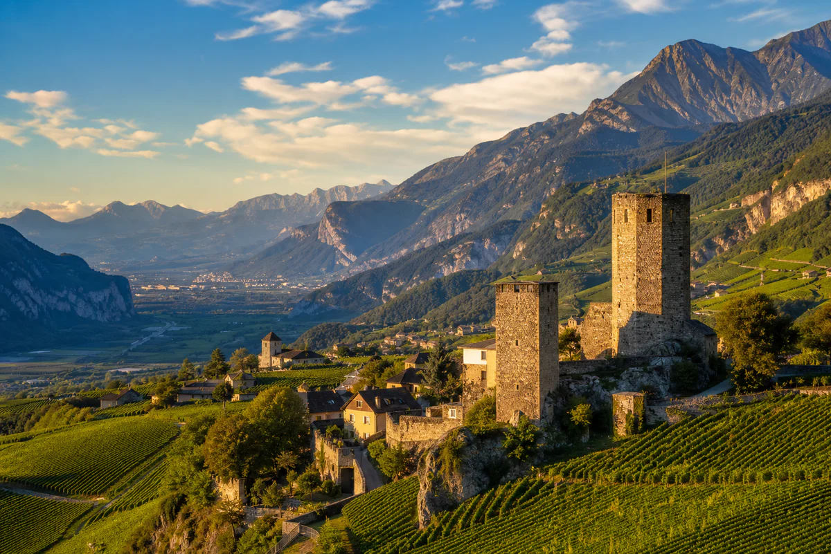 Panoramic view of the medieval stone towers of Chignin village overlooking terraced vineyards in the Savoie region of the Fre